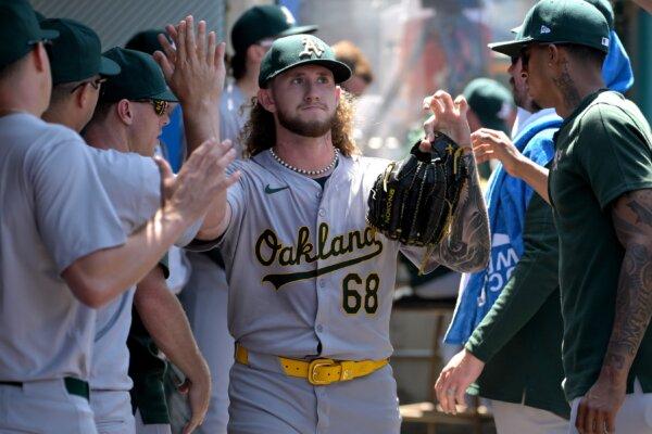 Joey Estes (68) of the Oakland Athletics gets high fives in the dugout after he was pulled in the sixth inning of the game against the Los Angeles Angels in Anaheim, Calif., on June 26, 2024. (Jayne Kamin-Oncea/Getty Images)