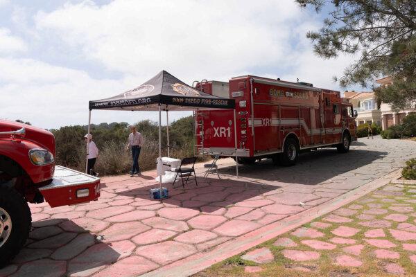 A stretch of pavement covered with pink fire retardant was seen on June 26, 2024 in the neighborhood nearby the area of the Torrey Pines State Natural Reserve North where firefighters contained the Del Mar fire erupted on June 25. (Jane Yang/The Epoch Times)