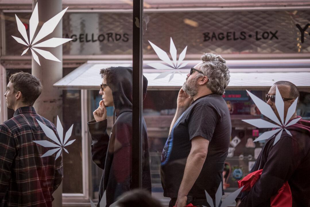 People stand in line to get into MedMen, one of the two Los Angeles area pot shops that began selling marijuana for recreational use under the new California law, in West Hollywood, Calif., on Jan. 2, 2018. (David McNew/Getty Images)