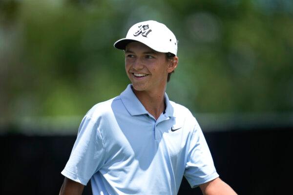 Amateur Miles Russell, 15 years old, smiles after his tee shot on the 10th hole during the first round of the Rocket Mortgage Classic in Detroit on June 27, 2024. (Paul Sancya/AP Photo)