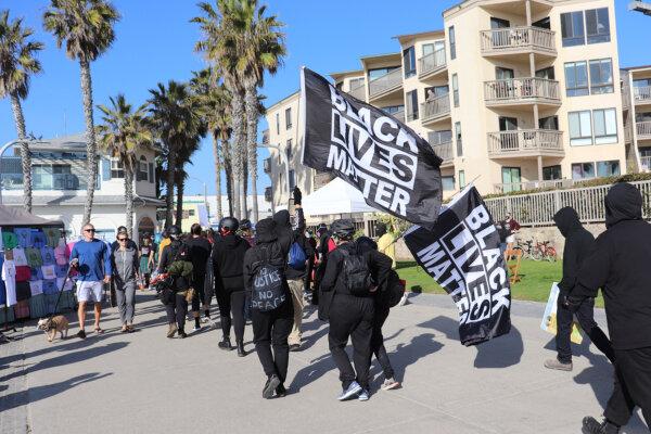 A group of counterprotesters dressed in black at a pro-Trump Patriot March rally at Pacific Beach in San Diego on Jan. 9, 2021. (Tina Deng/The Epoch Times)
