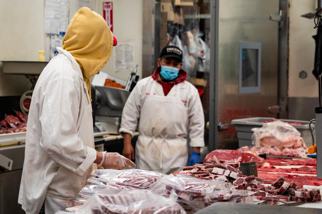 A butcher processes meat at Vincent's Meat Market in the Bronx borough of New York City on April 17, 2020. (David Dee Delgado/Getty Images)