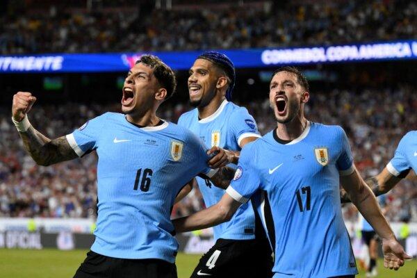 Uruguay's Matias Vina (L) celebrates teammate Mathias Olivera's goal against the United States during a Copa America Group C match in Kansas City on July 1, 2024. (Reed Hoffman/AP Photo)