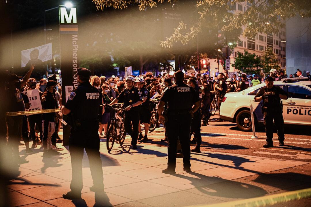 Police line up on Vermont Avenue as people protest over the death of George Floyd, in Washington on June 23, 2020. (Brendan Smialowski /AFP via Getty Images)