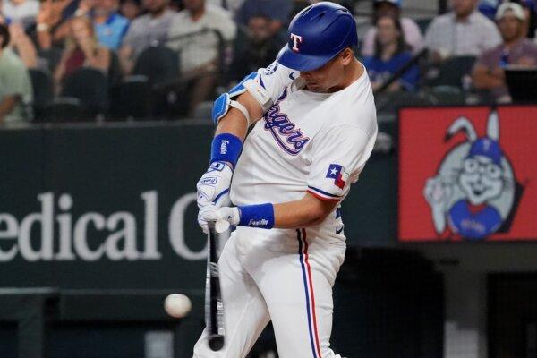 Nathaniel Lowe of the Rangers connects for one of his two home runs against the Padres in Arlington, Texas, on July 2, 2024. (LM Otero/AP Photo)