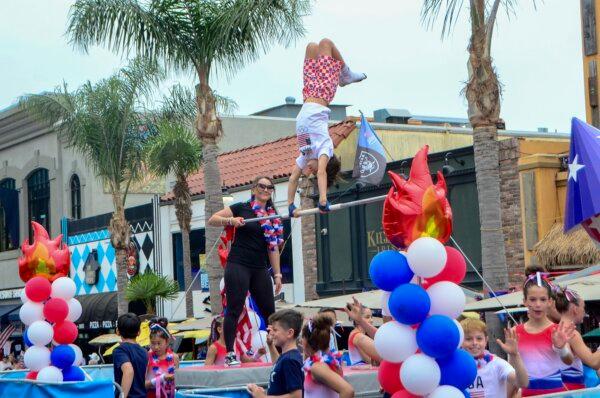 SCATS Gymnastics of Huntington Beach participates in the Independence Day parade in Huntington Beach, Calif., on July 4, 2024. (Alex Lee/The Epoch Times)