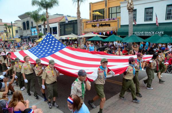 Boy Scouts of America participate in the Independence Day parade in Huntington Beach, Calif., on July 4, 2024. (Alex Lee/The Epoch Times)