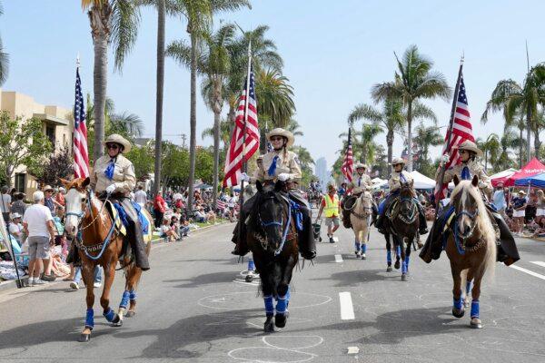 Escondido Mounted Posse participates in the Independence Day Parade in Coronado, Calif., on July 4, 2024. (Jane Yang/The Epoch Times)