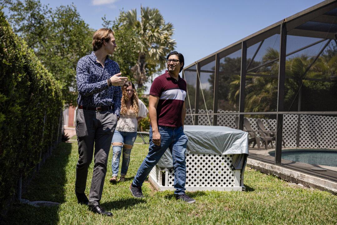 A real estate agent (L) shows a couple a home for sale in Cutler Bay, Fla., on April 20, 2023. (Joe Raedle/Getty Images)