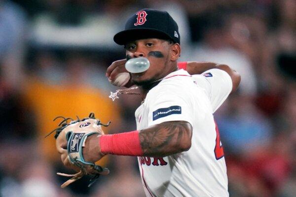 Red Sox shortstop Ceddanne Rafaela multitasks while making a play against the A's in Boston on July 9, 2024. (Charles Krupa/AP Photo)