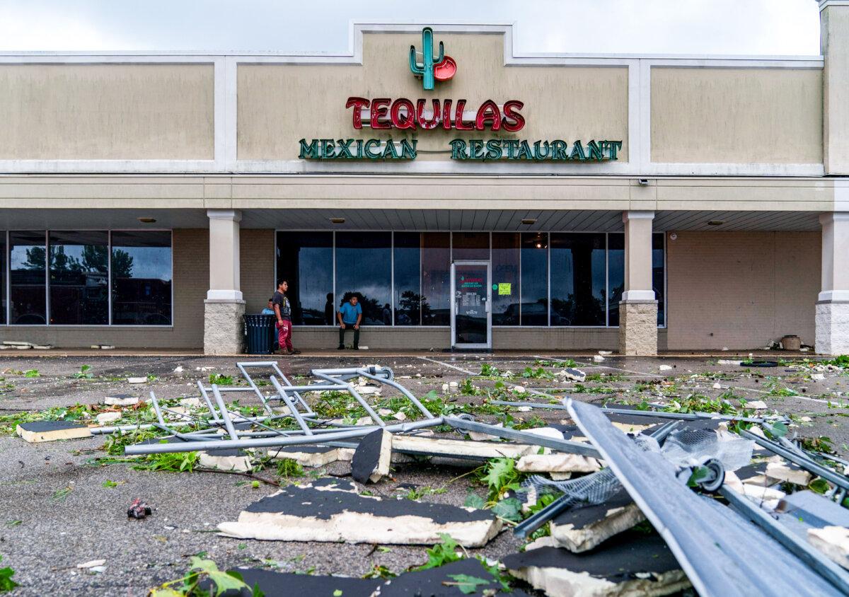 A cart return is mangled outside Tequilas Mexican Restaurant in the Southwind Plaza after an apparent tornado ripped through Mount Vernon, Ind., on July 9, 2024. (MaCabe Brown/Evansville Courier & Press via AP)