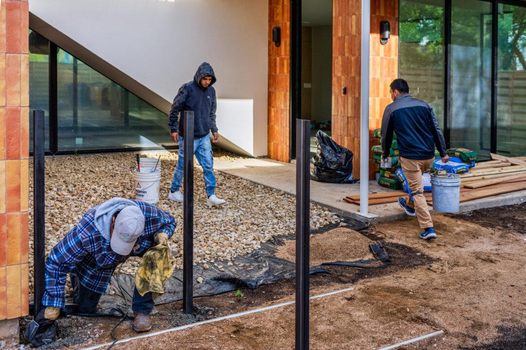 Construction workers work on a newly built house in Austin, Texas, on March 19, 2024. “A lot of builders just can’t afford to take on large residential development projects,” Mr. Mendenhall said. (Brandon Bell/Getty Images)