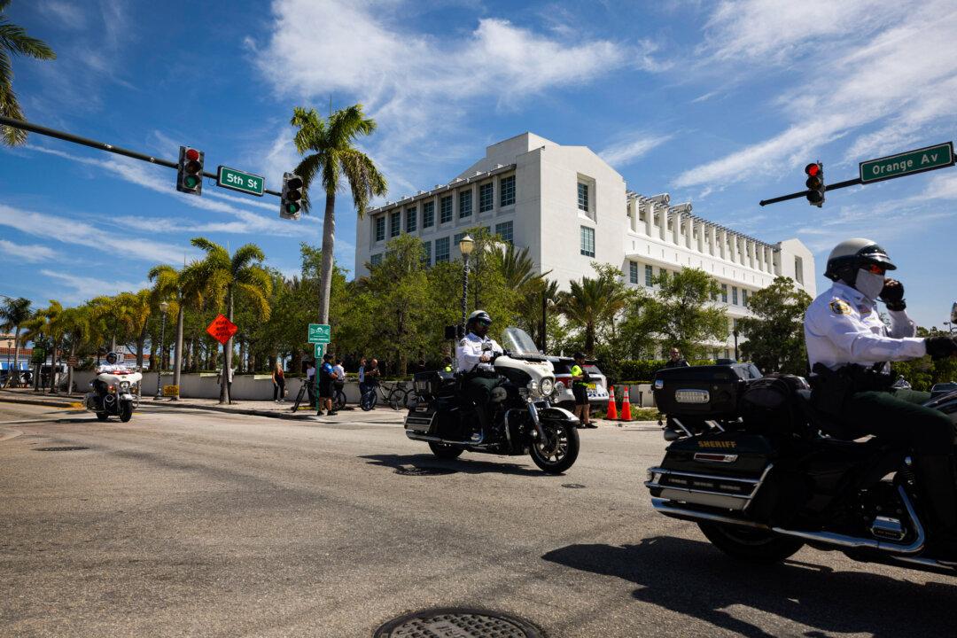 Palm Beach County sheriff's deputies drive past the Alto Lee Adams Sr. U.S. Courthouse in Fort Pierce, Fla., on March 14, 2024. Former President Donald Trump attended a hearing in front of U.S. District Judge Aileen Cannon. (Joe Raedle/Getty Images)