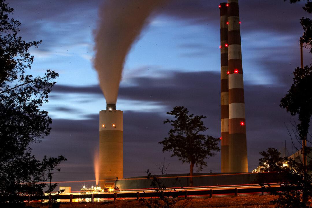 Smoke rises from the coal-fired Morgantown Generating Station in Newburg, Md., on Oct. 10, 2017. More than one-fourth of Americans now reside in a state with a cap-and-trade program, according to the Center for Climate and Energy Solutions. (Mark Wilson/Getty Images)