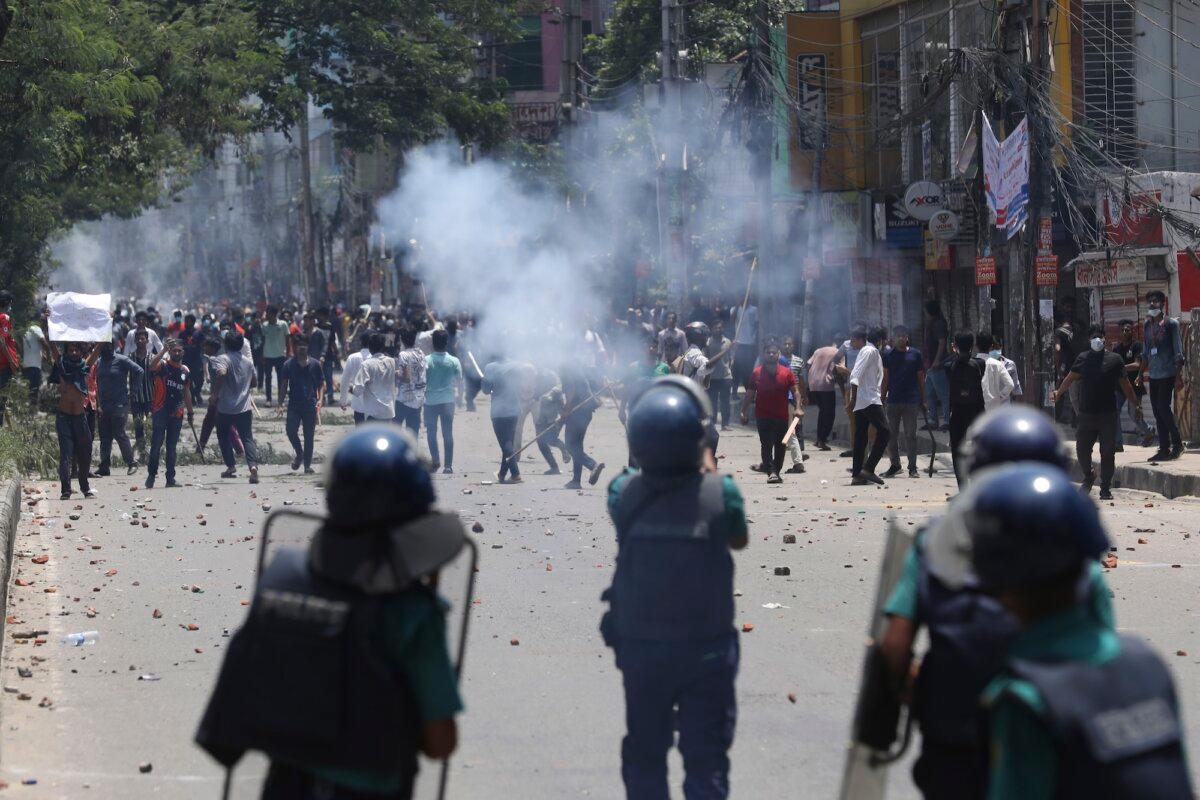 Students clash with riot police during a protest against a quota system for government jobs, in Dhaka, Bangladesh, on July 18, 2024. (Rajib Dhar/AP Photo)