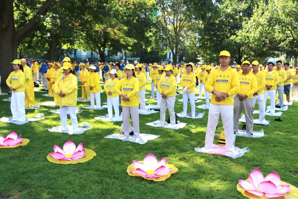 Falun Gong practitioners perform their meditative exercises during an event held at Queen's Park in Toronto on July 20, 2024. The event marks the 25th anniversary of the Chinese regime's persecution of Falun Gong. (Andrew Chen/ The Epoch Times)