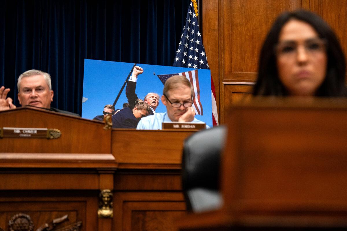 A photograph of Former President Donald Trump by Associated Press photographer Evan Vucci is seen as United Sates Secret Service Director Kimberly Cheatle testifies before the House Oversight and Accountability Committee during a hearing at Capitol on July 22, 2024. (Kent Nishimura/Getty Images)