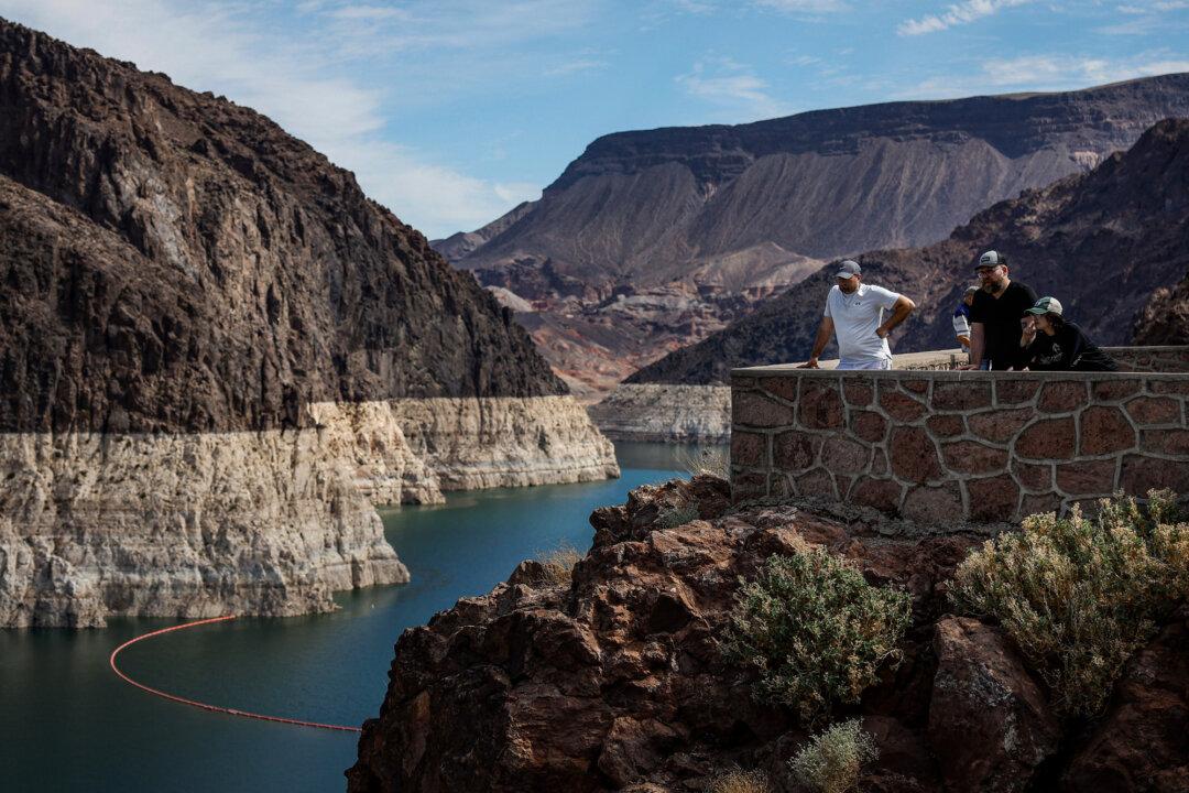 Park visitors look at the bleached “bathtub ring” visible on the banks of Lake Mead near the Hoover Dam in Lake Mead National Recreation Area, Ariz., on Aug. 19, 2022. (Justin Sullivan/Getty Images)