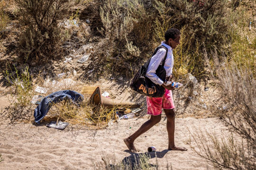 A homeless person walks barefoot in 107 degree Fahrenheit heat near Lancaster, Calif., on July 10, 2024. (John Fredricks/The Epoch Times)