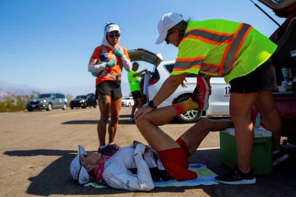 Karla Kent stretches during a brief pause along California Route 190 during the Badwater 135-mile ultramarathon in Death Valley, Calif., on July 23, 2024. (Ty O'Neil/AP Photo)