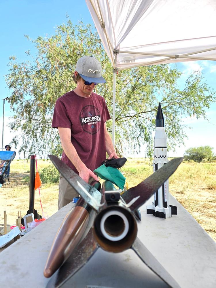 Bradley Swainston of Mesa, Ariz., works on a high-powered model rocket to earn his Level 2 certification during a Southern Arizona Rocketry Association club launch on July 14, 2024. (Allan Stein/The Epoch Times)