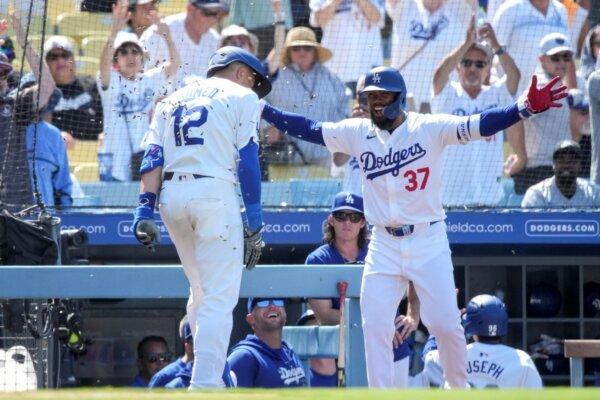 Nick Ahmed (L), released by the Giants earlier this month, receives congratulations from Dodgers teammate Teoscar Hernandez after hitting a tie-breaking, eighth-inning home run against his former team in Los Angeles on July 25, 2024. (Eric Thayer/AP Photo)