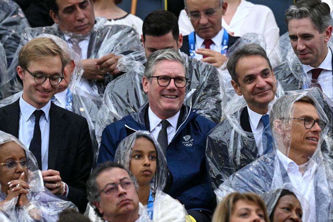 Britain's Prime Minister Keir Starmer (C) and Greece's Prime Minister Kyriakos Mitsotakis (R) attend the opening ceremony of the Paris 2024 Olympic Games in Paris on July 26, 2024. (Oli Scarff/AFP via Getty Images)