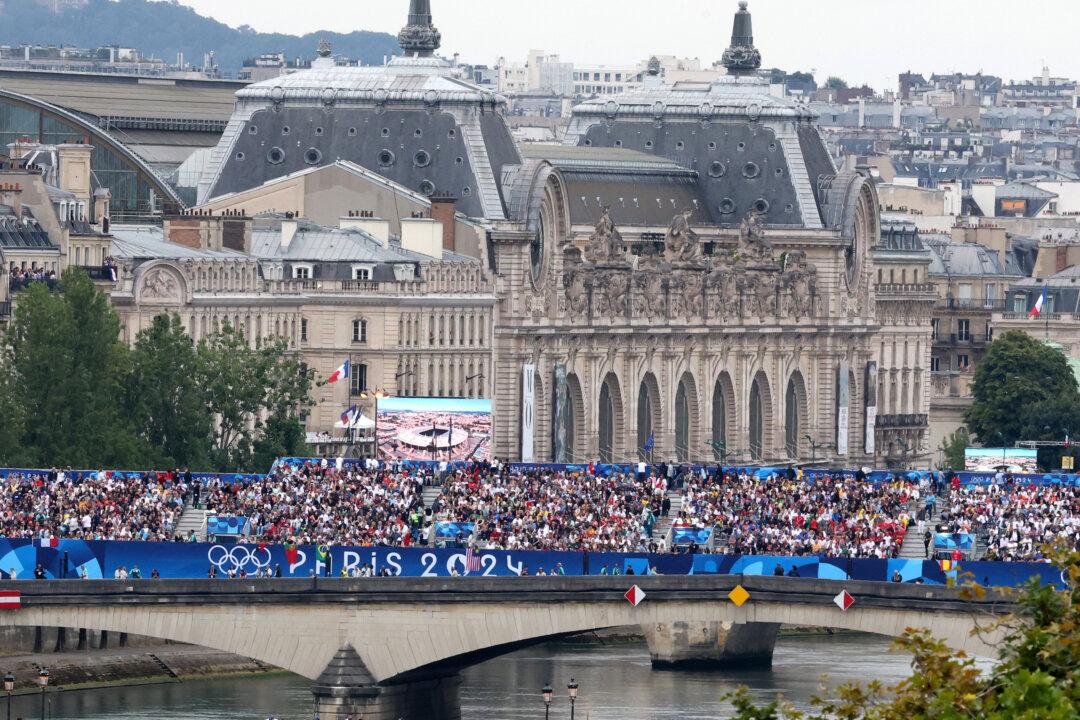 Spectators on a bridge over the River Seine during the opening ceremony of the Paris 2024 Olympic Games Paris on July 26, 2024. (Zhang Yuwei-Pool/Getty Images)