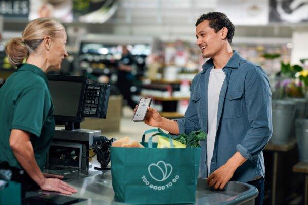 A man showing his proof of purchase within the “Too Good To Go” app while picking up his surprise bag. (Courtesy of Too Good To Go)