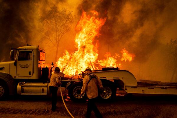 Firefighters spray water as the Park Fire tears through the Cohasset community in Butte County, Calif., on July 25, 2024. (Noah Berger/AP Photo)