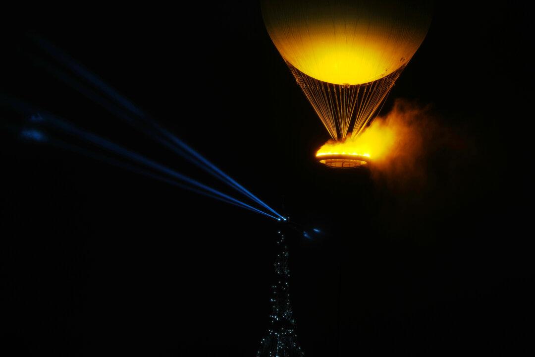 A balloon carrying the lit Olympic cauldron lifts off with the Eiffel Tower in the background during the opening ceremony of the Paris 2024 Olympic Games in Paris, France, on July 26, 2024. (Xia Yifang - Pool/Getty Images)