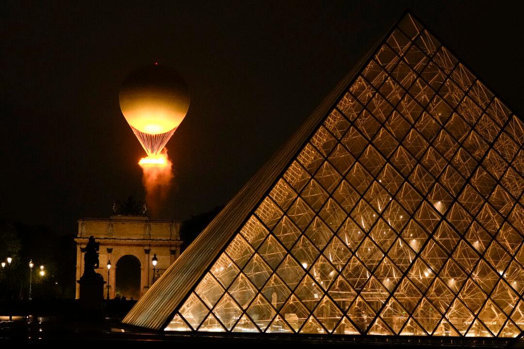 The Olympic Flame rises on a balloon after being lit in Paris, France, during the opening ceremony of the 2024 Summer Olympics, on July 26, 2024. (Francisco Seco/AP Photo)