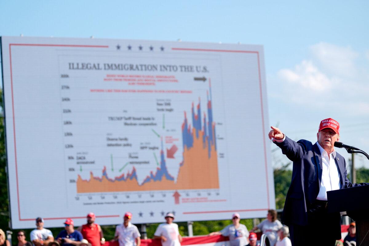 Former President Donald Trump points to an immigration data chart on display moments before he was shot at Butler Farm Show in Butler, Pa., on July 13, 2024. (Evan Vucci/AP Photo)