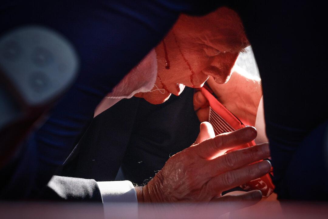 Former President Donald Trump is surrounded by U.S. Secret Service agents after he was shot. (Evan Vucci/AP Photo, Anna Moneymaker/Getty Images)