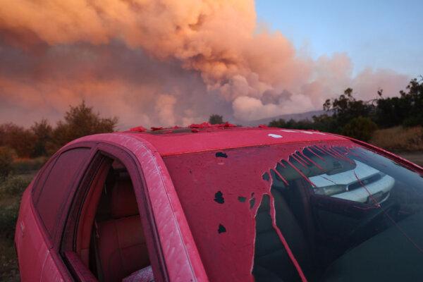 The fire retardant Phos-Chek coats a vehicle during the Nixon Fire with evacuation orders A firefighter works as the Nixon Fire burns with evacuation orders in the area, near Aguanga of Riverside County, Calif., on July 29, 2024. (Mario Tama/Getty Images)