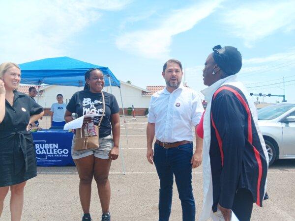 Rep. Ruben Gallego (D-Ariz.) and his ex-wife, Kate Gallego (L), speak to reporters after voting in the Arizona Democratic Primary election on July 30, 2024. (Nathan Worcester/The Epoch Times)