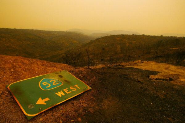 A sign for the 52 freeway lies among the hills charred by the Cedar fire near Lakeside in San Diego on Oct. 27, 2003. (Donald Miralle/Getty Images)