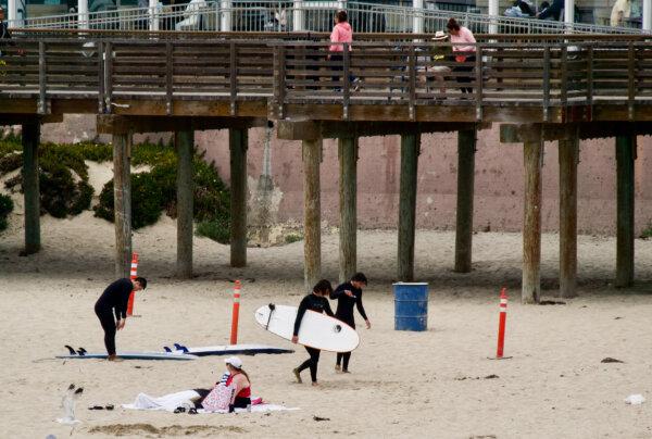 Surfers and families enjoying Pismo Beach, Calif., on July 18, 2024. (Travis Gillmore/The Epoch Times)