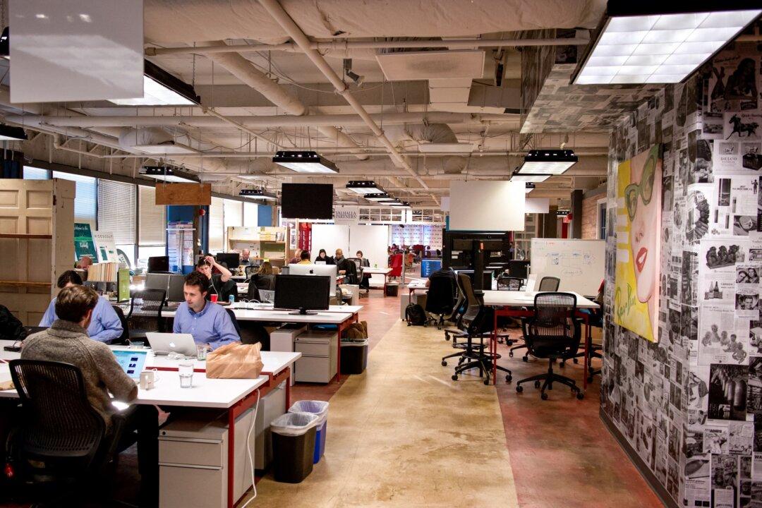 Employees work in an office in Washington on Feb. 11, 2014. Remote workers were promoted 31 percent less often than employees working an in-office or hybrid schedule in 2023, according to an analysis. (Mladen Antonov/AFP via Getty Images)