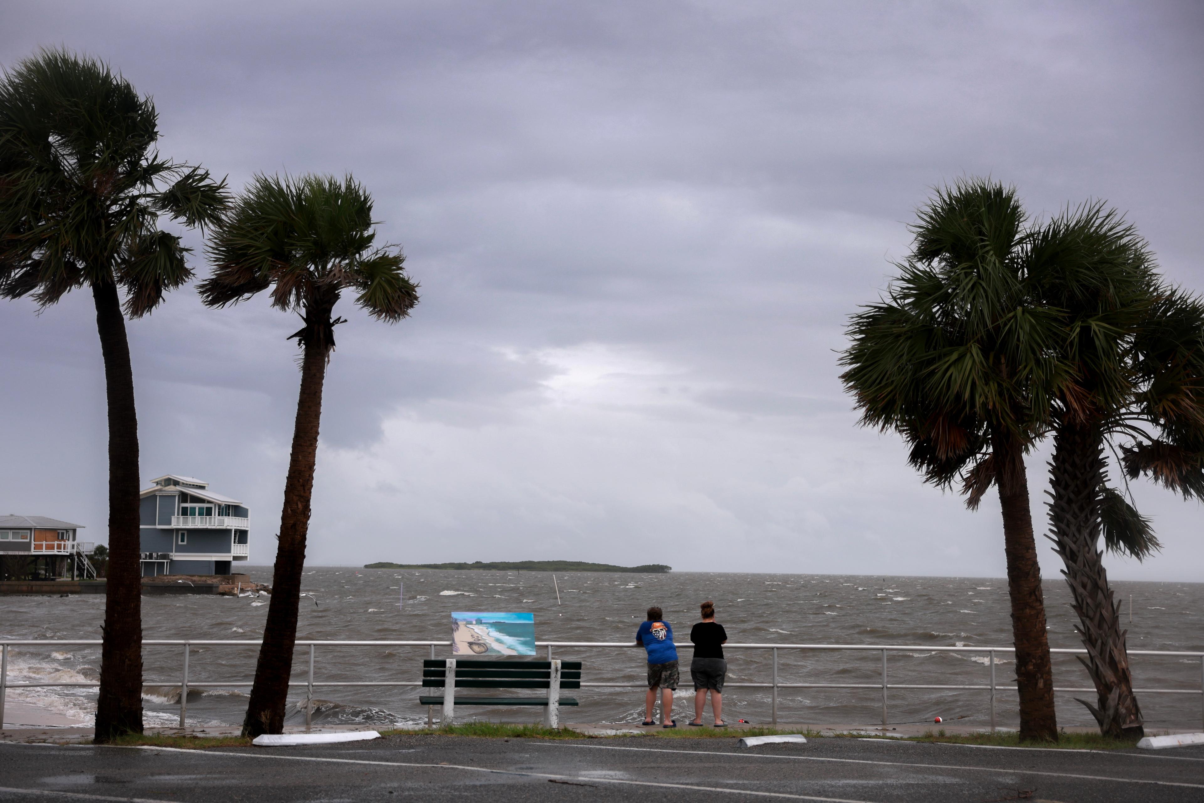 People look out at the gathering storm before the possible arrival of Tropical Storm Debby, which is strengthening as it moves through the Gulf of Mexico on August 04, 2024 in Cedar Key, Florida. (Joe Raedle/Getty Images)