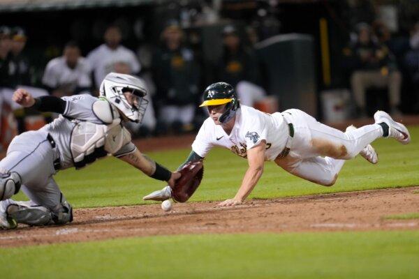 White Sox catcher Korey Lee can't corral a throw to the plate as Zack Gelof scores the A's final run during a game in Oakland, Calif., on Aug. 5, 2024. (Jeff Chiu/AP Photo)