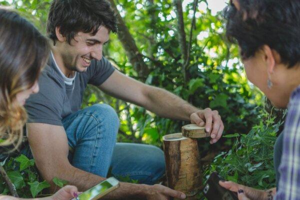 A group finding a geocache. (Courtesy of Groundspeak Inc. (dba Geocaching))