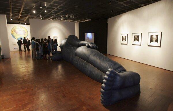 Guests look at works of art at the "The Missing Peace: Artists Consider the Dalai Lama" Art Exhibition Preview at the UCLA Fowler Museum, in Westwood, Calif., on June 9, 2006. (Frazer Harrison/Getty Images)