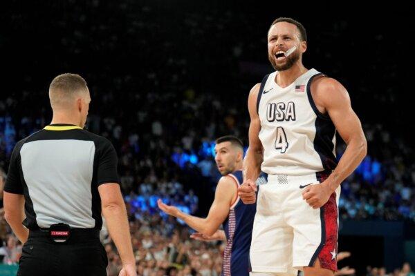 Stephen Curry of Team USA reacts after hitting a big basket in the final minutes against Serbia at the Paris Olympics on Aug. 8, 2024. (Mark J. Terrill/AP Photo)