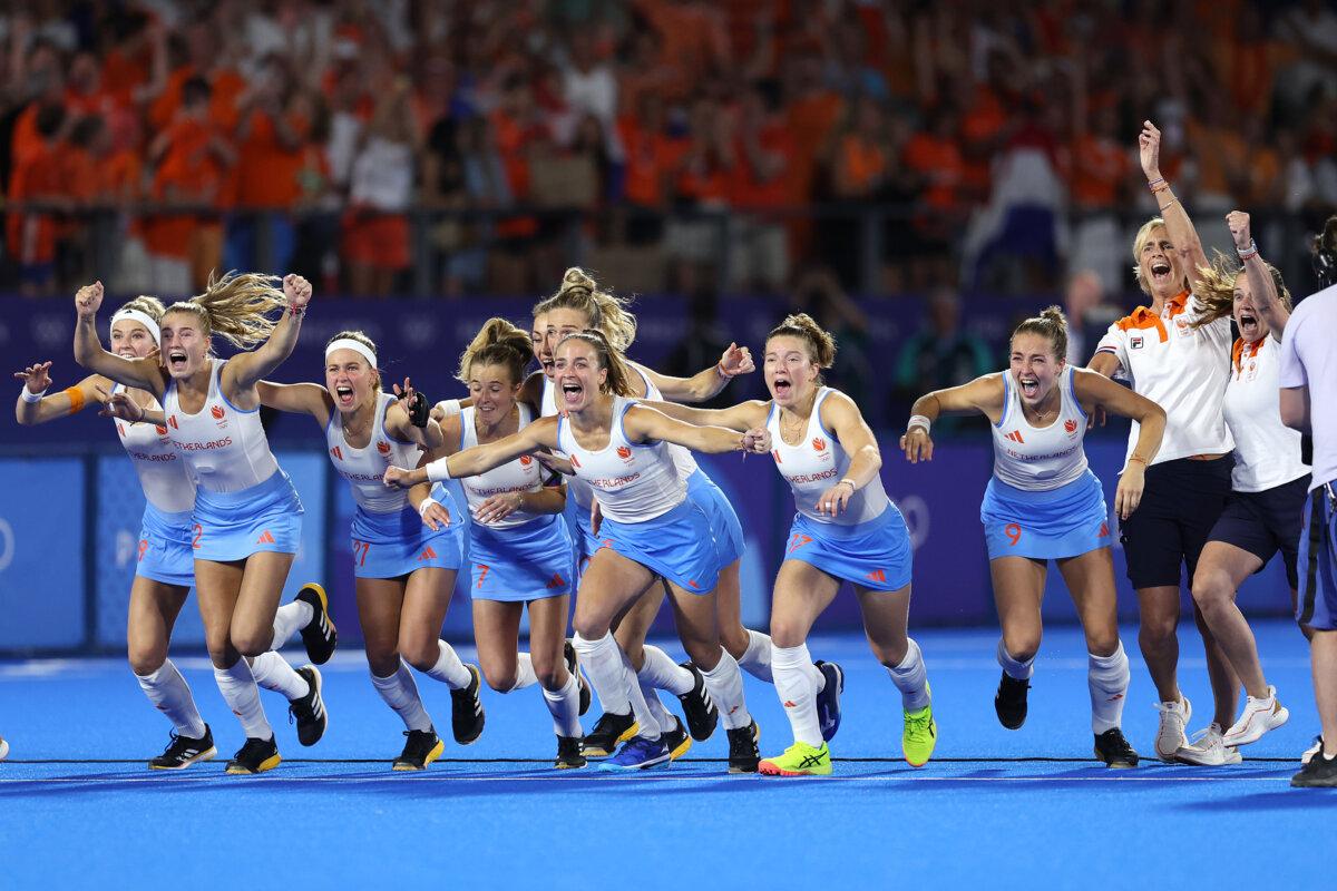 Members of Team Netherlands celebrate following victory in the women's gold medal match between Netherlands and China on day 14 of the Olympic Games at Stade Yves Du Manoir in Paris on Aug. 9, 2024. (Clive Brunskill/Getty Images)