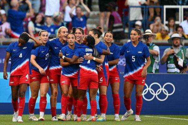 US' forward (9) Mallory Swanson (4L) celebrates with teammates scoring the opening goal in the women's gold medal final football match between Brazil and US during the Paris 2024 Olympic Games in Paris on Aug. 10, 2024. (Patricia De Melo Moreira/AFP/Getty Images)