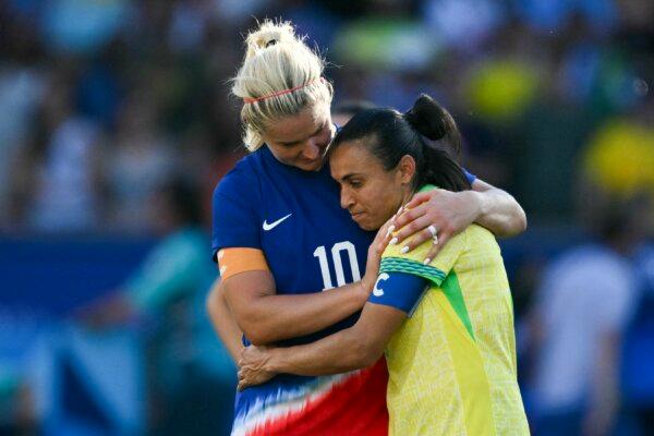 US' midfielder (10) Lindsey Horan (L) conforts Brazil's forward (10) Marta at the end of the women's gold medal final football match between Brazil and US during the the Paris 2024 Olympic Games in Paris on Aug. 10, 2024. (Jonathan Nackstrand/AFP/Getty Images))