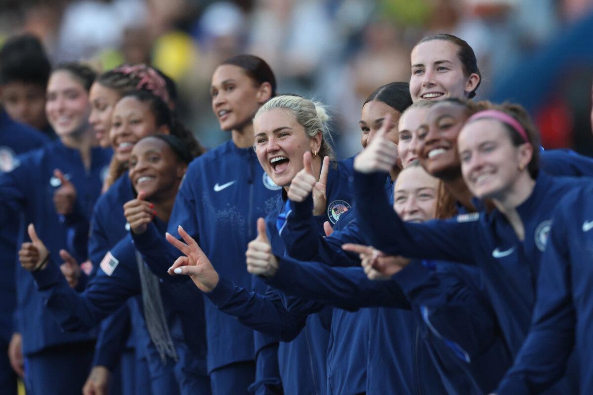 Gold medalist Lindsey Horan (10) of Team United States and teammates celebrate in the podium during the women's football medal ceremony during the Olympic Games at Parc des Princes in Paris on Aug. 10, 2024. (Carl Recine/Getty Images)