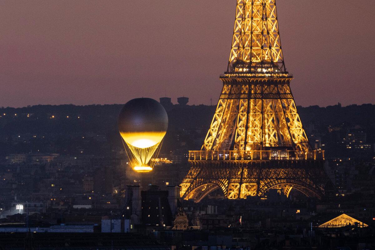 Olympic cauldron as it rises high near the Eiffel Tower on day fifteen of the Olympic Games in Paris on Aug. 10, 2024. (Maja Hitij/Getty Images)