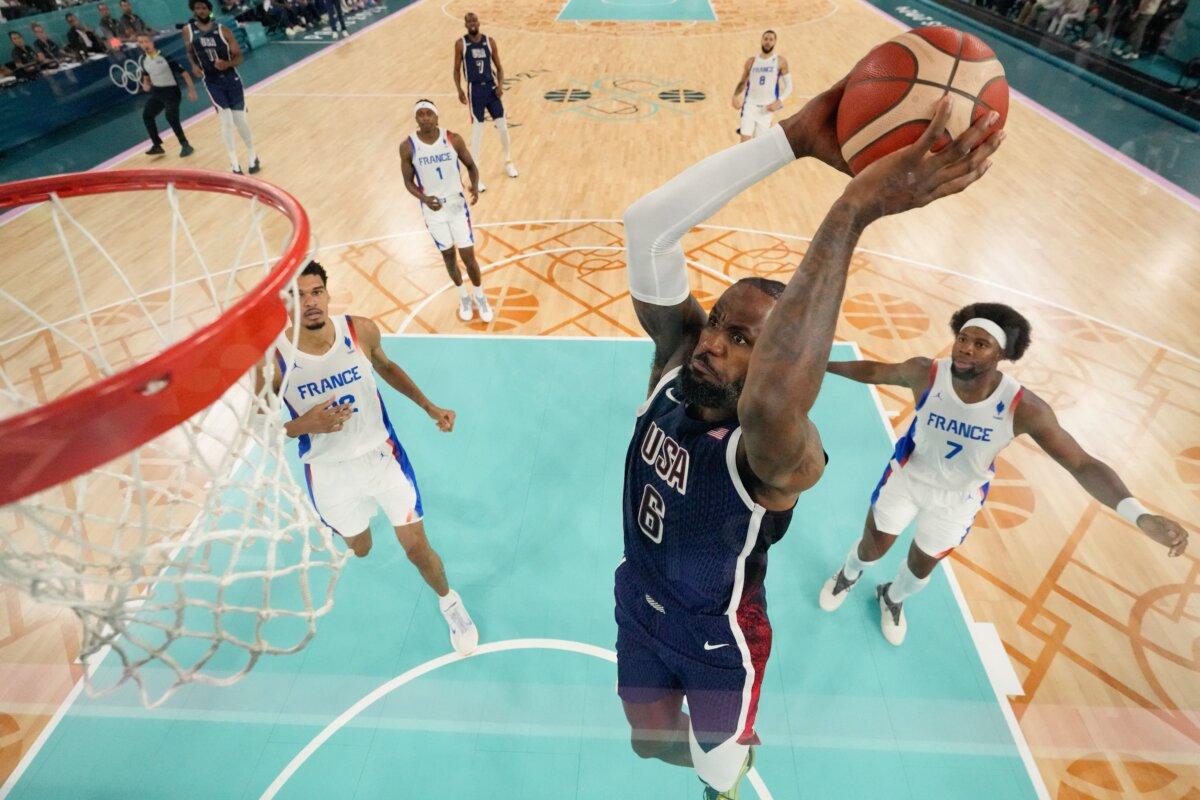 USA's (6) LeBron James dunks the ball in the men's gold medal basketball match between France and USA during the Olympic Games at the Bercy Arena in Paris on Aug. 10, 2024. (Mark Terrill/POOL/AFP via Getty Images)